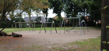 Spielbereich auf dem Schulhof, mit Schaukeln und Rutsche