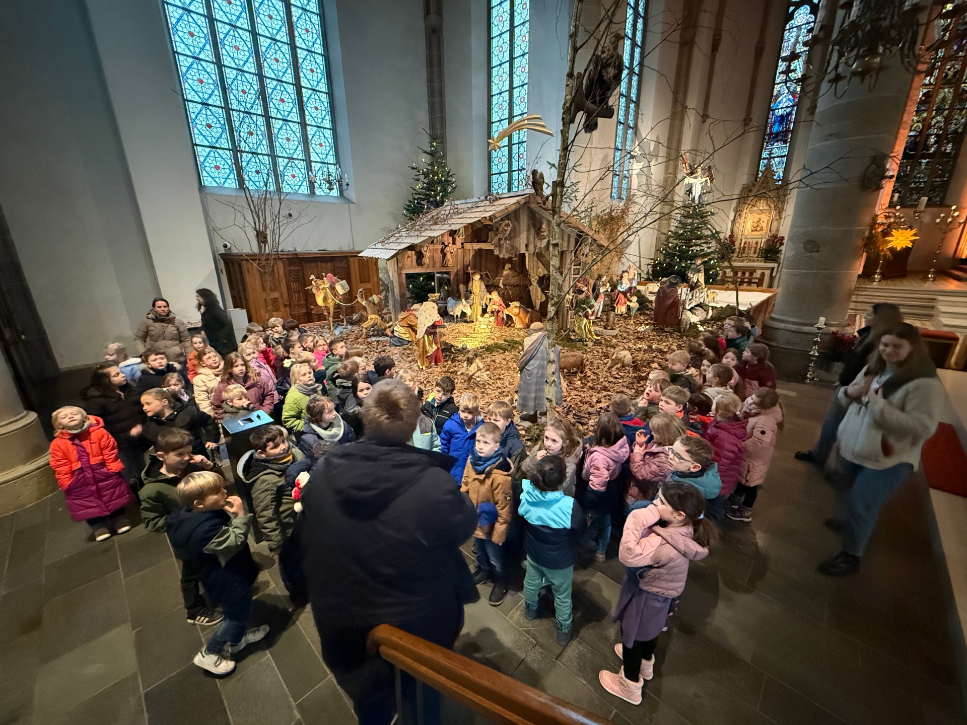 Kinder stehen vor der Krippe.